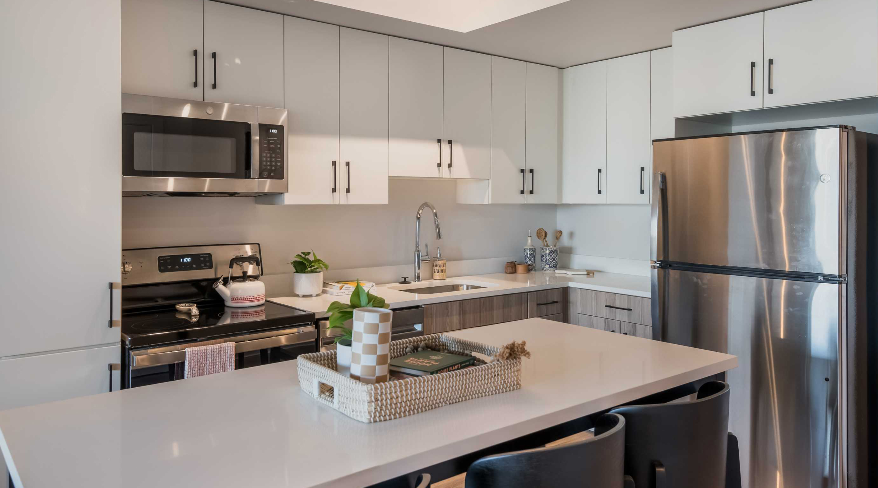 A kitchen with white cabinets